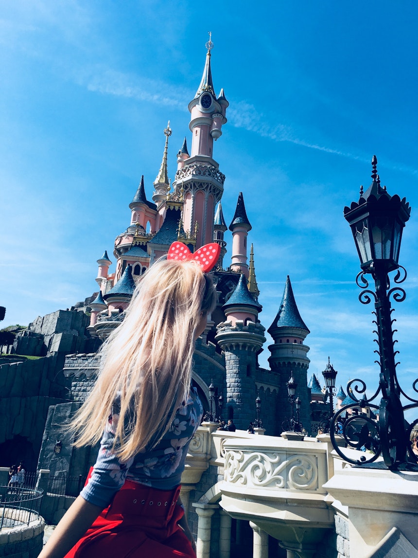 Girl outside a castle in Disneyland