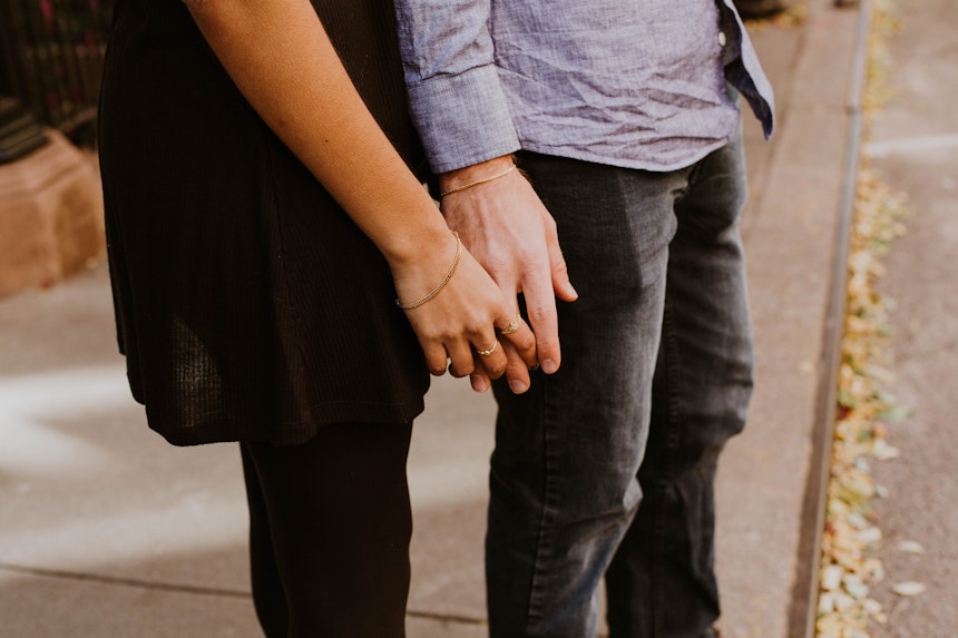 Couple holding hands.