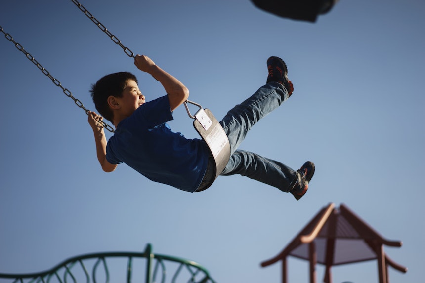 Boy playing on a swing